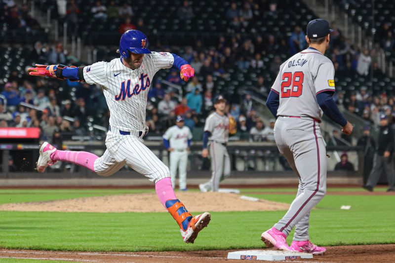 May 12, 2024; New York City, New York, USA; New York Mets second baseman Jeff McNeil (1) reaches first base safely behind Atlanta Braves first baseman Matt Olson (28) on a bunt for a base hit during the ninth inning at Citi Field. Mandatory Credit: Vincent Carchietta-USA TODAY Sports