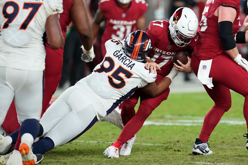 Denver Broncos defensive tackle Elijah Garcia (95) sacks Arizona Cardinals quarterback David Blough during the second half of an NFL preseason football game in Glendale, Ariz., Friday, Aug. 11, 2023. (AP Photo/Ross D. Franklin)