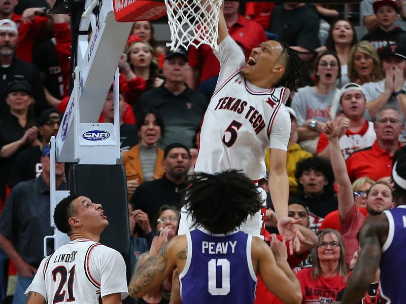 Feb 20, 2024; Lubbock, Texas, USA;  Texas Tech Red Raiders guard Darrion Williams (5) slam dunks the ball in front of TCU Horned Frogs guard Micah Peavy (0) in the second half at United Supermarkets Arena. Mandatory Credit: Michael C. Johnson-USA TODAY Sports