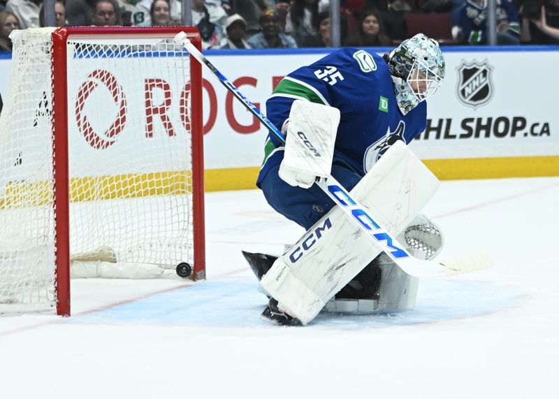 Apr 2, 2025; Vancouver, British Columbia, CAN; Seattle Kraken forward Michael Eyssimont (21) scores against Vancouver Canucks goaltender Thatcher Demko (35) during the first period at Rogers Arena. Mandatory Credit: Simon Fearn-Imagn Images
