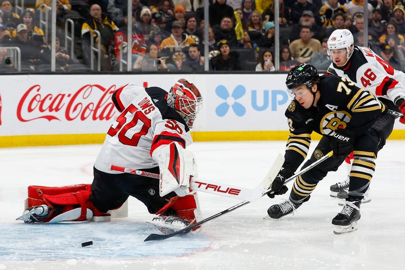 Jan 15, 2024; Boston, Massachusetts, USA; Boston Bruins defenseman Charlie McAvoy (73) dekes New Jersey Devils goaltender Nico Daws (50) but can t score during the third period at TD Garden. Mandatory Credit: Winslow Townson-USA TODAY Sports