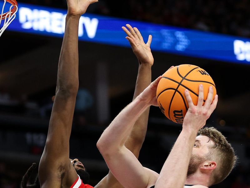 Mar 14, 2024; Minneapolis, MN, USA; Iowa Hawkeyes forward Ben Krikke (23) shoots as Ohio State Buckeyes guard Evan Mahaffey (12) defends during the first half at Target Center. Mandatory Credit: Matt Krohn-USA TODAY Sports