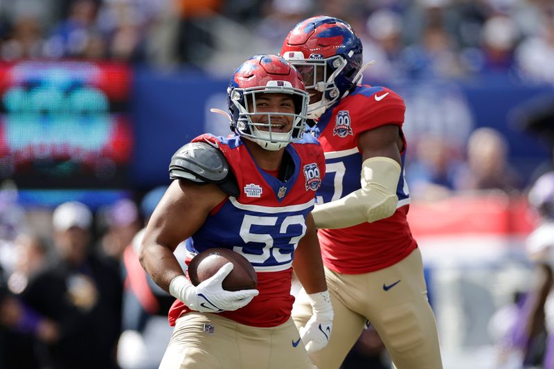 New York Giants linebacker Darius Muasau (53) celebrates after intercepting a pass during the second half of an NFL football game against the Minnesota Vikings, Sunday, Sept. 8, 2024, in East Rutherford, N.J. (AP Photo/Adam Hunger)