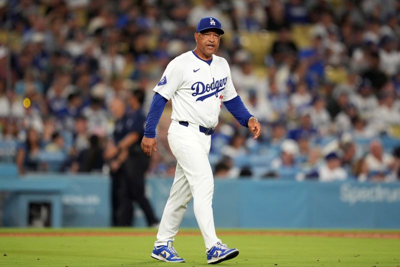 Aug 20, 2024; Los Angeles, California, USA; Los Angeles Dodgers manager Dave Roberts (30) reacts during the game against the Seattle Mariners at Dodger Stadium. Mandatory Credit: Kirby Lee-USA TODAY Sports