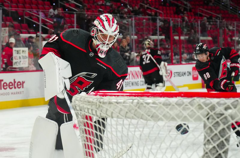 Jan 21, 2024; Raleigh, North Carolina, USA;  Carolina Hurricanes goalie Spencer Martin (41) takes a shot during the warmups against the Minnesota Wild at PNC Arena. Mandatory Credit: James Guillory-USA TODAY Sports