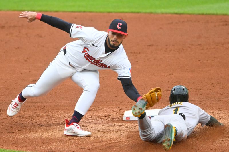 Apr 20, 2024; Cleveland, Ohio, USA; Cleveland Guardians second baseman Gabriel Arias (13) tags out Oakland Athletics center fielder Esteury Ruiz (1) on an attempted steal of second base in the third inning at Progressive Field. Mandatory Credit: David Richard-USA TODAY Sports