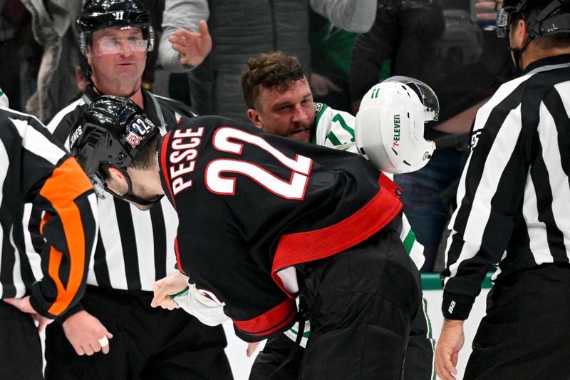 Jan 25, 2023; Dallas, Texas, USA; Carolina Hurricanes defenseman Brett Pesce (22) fights with Dallas Stars center Luke Glendening (11) during the second period at the American Airlines Center. Mandatory Credit: Jerome Miron-USA TODAY Sports