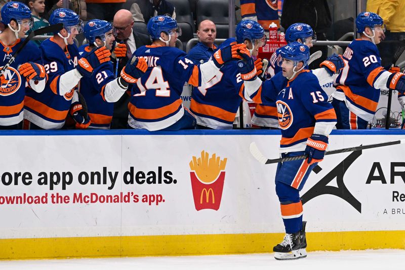 Mar 23, 2024; Elmont, New York, USA;  New York Islanders right wing Cal Clutterbuck (15) celebrates his second goal during the first period  against the Winnipeg Jets at UBS Arena. Mandatory Credit: Dennis Schneidler-USA TODAY Sports