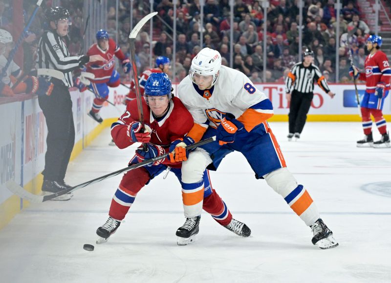 Jan 25, 2024; Montreal, Quebec, CAN; Montreal Canadiens forward Cole Caufield (22) and New York Islanders defenseman Noah Dobson (8) battle for the puck during the third period at the Bell Centre. Mandatory Credit: Eric Bolte-USA TODAY Sports