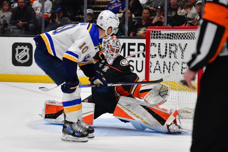 Apr 7, 2024; Anaheim, California, USA; St. Louis Blues center Brayden Schenn (10) shoots wide as Anaheim Ducks goaltender Lukas Dostal (1) defends the goal during the shootout at Honda Center. Mandatory Credit: Gary A. Vasquez-USA TODAY Sports