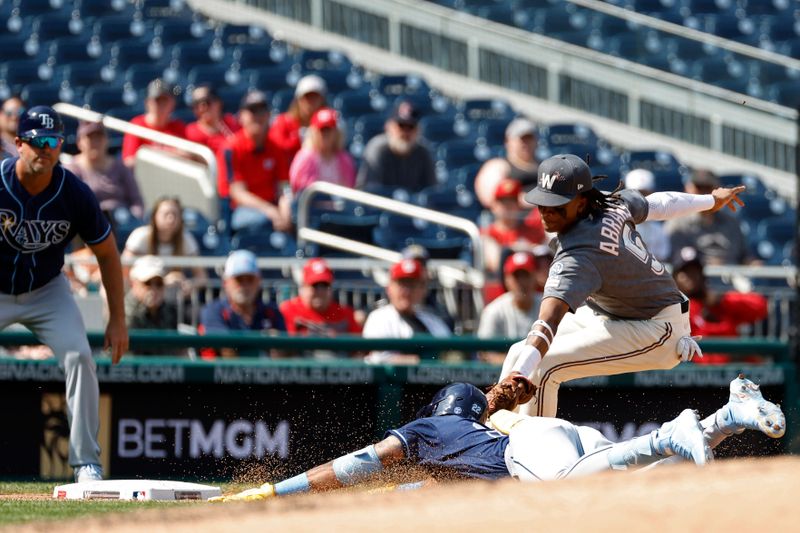 Apr 5, 2023; Washington, District of Columbia, USA; Tampa Bay Rays center fielder Jose Siri (22) is tagged out at third base on a throw to Washington Nationals shortstop CJ Abrams (5) during the sixth inning at Nationals Park. Mandatory Credit: Geoff Burke-USA TODAY Sports