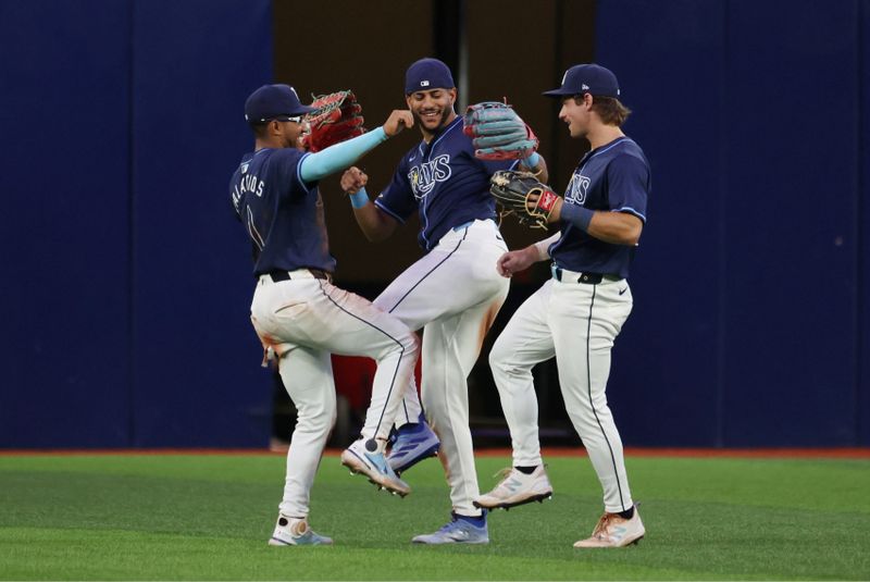 Jun 25, 2024; St. Petersburg, Florida, USA; Tampa Bay Rays outfielder Richie Palacios (1), outfielder Jose Siri (22), and outfielder Jonny DeLuca (21) celebrate after they beat the Seattle Mariners at Tropicana Field. Mandatory Credit: Kim Klement Neitzel-USA TODAY Sports