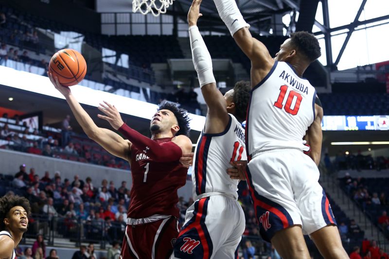 Feb 11, 2023; Oxford, Mississippi, USA; South Carolina Gamecocks guard Jacobi Wright (1) shoots as Mississippi Rebels guard Matthew Murrell (11) and forward Theo Akwuba (10) defend during the first half at The Sandy and John Black Pavilion at Ole Miss. Mandatory Credit: Petre Thomas-USA TODAY Sports