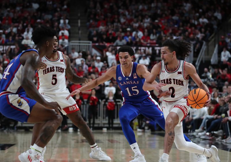 Jan 3, 2023; Lubbock, Texas, USA;  Texas Tech Red Raiders guard Pop Isaacs (2) dribbles the ball against Kansas Jayhawks forward Kevin McCullar Jr (15) in the second half at United Supermarkets Arena. Mandatory Credit: Michael C. Johnson-USA TODAY Sports