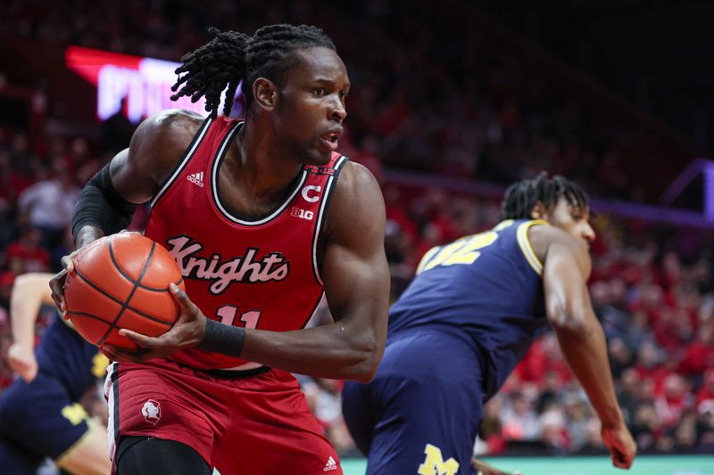 Feb 29, 2024; Piscataway, New Jersey, USA; Rutgers Scarlet Knights center Clifford Omoruyi (11) secures a rebound during the first half against the Michigan Wolverines at Jersey Mike's Arena. Mandatory Credit: Vincent Carchietta-USA TODAY Sports