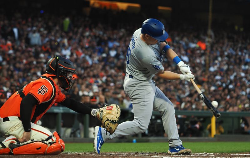 Jun 28, 2024; San Francisco, California, USA; Los Angeles Dodgers catcher Will Smith (16) hits a RBI single against the San Francisco Giants during the fifth inning at Oracle Park. Mandatory Credit: Kelley L Cox-USA TODAY Sports