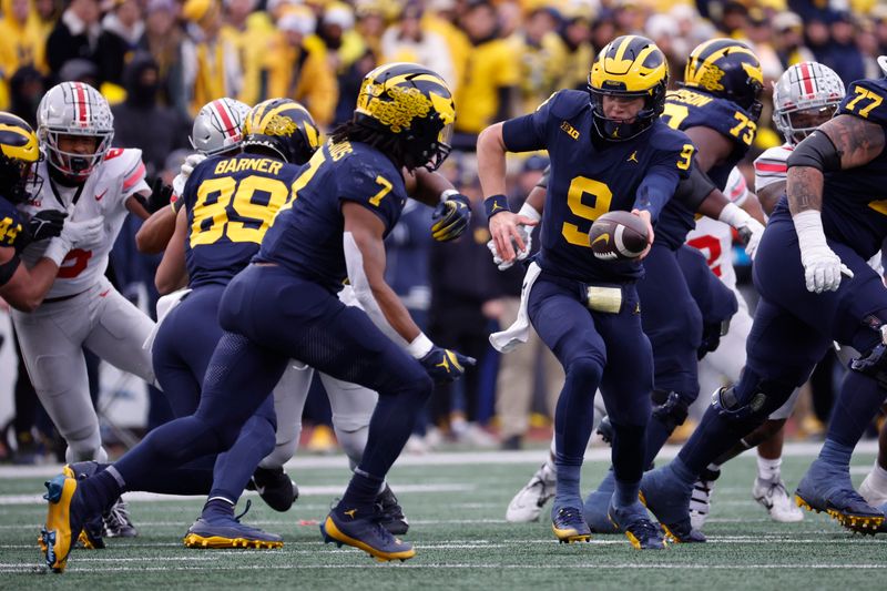 Nov 25, 2023; Ann Arbor, Michigan, USA; Michigan Wolverines quarterback J.J. McCarthy (9) hands of to running back Donovan Edwards (7) in the second half at Michigan Stadium. Mandatory Credit: Rick Osentoski-USA TODAY Sports