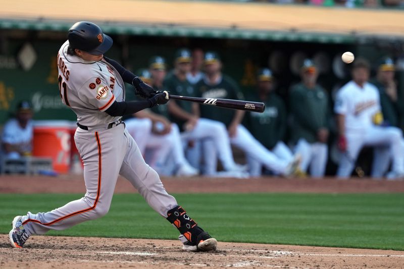 Aug 5, 2023; Oakland, California, USA; San Francisco Giants designated hitter Wilmer Flores (41) hits a single against the Oakland Athletics during the eighth inning at Oakland-Alameda County Coliseum. Mandatory Credit: Darren Yamashita-USA TODAY Sports