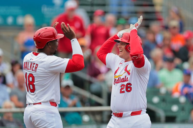 Feb 24, 2025; Jupiter, Florida, USA; St. Louis Cardinals first baseman Luken Baker (26) celebrates with outfielder Jordan Walker (18) after hitting a three-run home run against the New York Mets during the second inning at Roger Dean Chevrolet Stadium. Mandatory Credit: Sam Navarro-Imagn Images