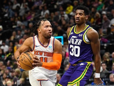 SALT LAKE CITY, UTAH - DECEMBER 13: Jalen Brunson #11 of the New York Knicks drives into Ochai Agbaji #30 of the Utah Jazz during the first half of a game at Delta Center on December 13, 2023 in Salt Lake City, Utah. NOTE TO USER: User expressly acknowledges and agrees that, by downloading and or using this photograph, User is consenting to the terms and conditions of the Getty Images License Agreement. (Photo by Alex Goodlett/Getty Images)