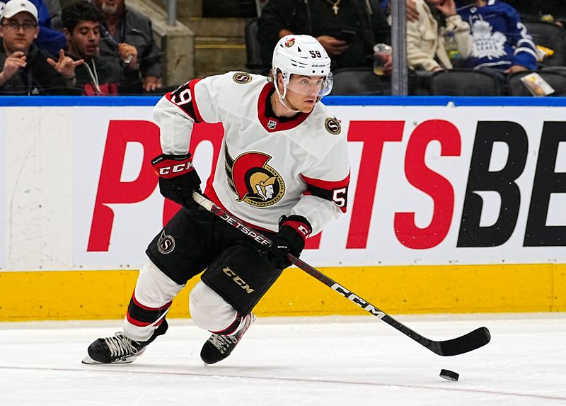 Sep 24, 2022; Toronto, Ontario, CAN; Ottawa Senators forward Angus Crookshank (59) carries the puck against the Toronto Maple Leafs during the third period at Scotiabank Arena. Mandatory Credit: John E. Sokolowski-USA TODAY Sports