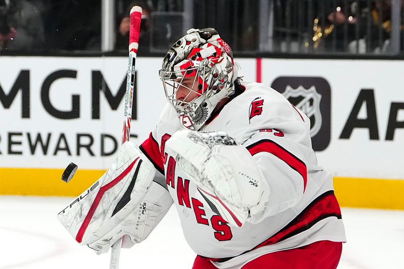 Nov 11, 2024; Las Vegas, Nevada, USA; Carolina Hurricanes goaltender Pyotr Kochetkov (52) makes a save against the Vegas Golden Knights during the second period at T-Mobile Arena. Mandatory Credit: Stephen R. Sylvanie-Imagn Images