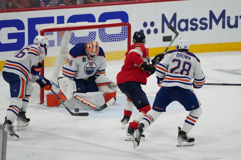 Jun 24, 2024; Sunrise, Florida, USA; Edmonton Oilers goaltender Skinner Stuart (74) and defenseman Philip Broberg (86) defend against Florida Panthers forward Sam Bennett (9) during the third period in game seven of the 2024 Stanley Cup Final at Amerant Bank Arena. Mandatory Credit: Jim Rassol-USA TODAY Sports