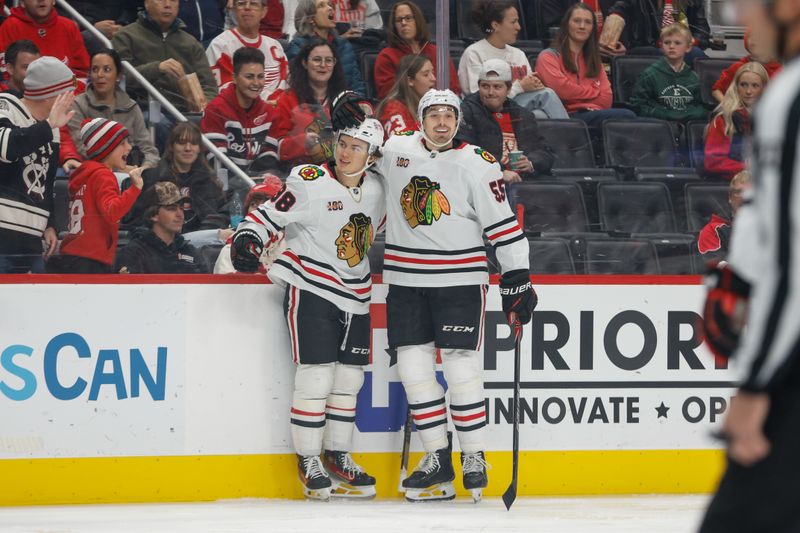 Nov 9, 2025; Detroit, Michigan, USA;  Chicago Blackhawks center Connor Bedard (98) celebrates with defenseman Artyom Levshunov (55) after scoring a goal in the first period at Little Caesars Arena. Mandatory Credit: Brian Bradshaw Sevald-Imagn Images