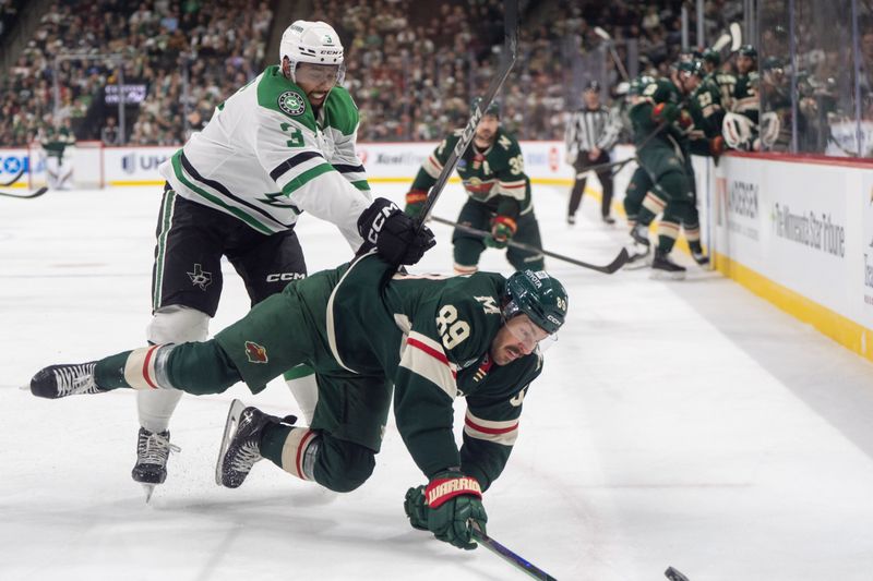 Apr 6, 2025; Saint Paul, Minnesota, USA; Dallas Stars defenseman Mathew Dumba (3) upends Minnesota Wild center Frederick Gaudreau (89) in the second period at Xcel Energy Center. Mandatory Credit: Matt Blewett-Imagn Images