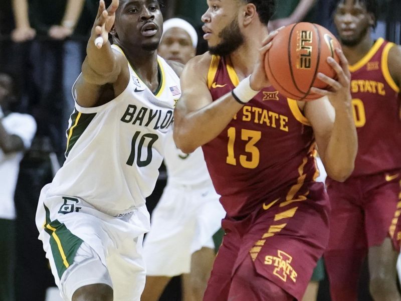 Mar 4, 2023; Waco, Texas, USA; Iowa State Cyclones guard Jaren Holmes (13) controls the ball against Baylor Bears guard Adam Flagler (10) during the second half at Ferrell Center. Mandatory Credit: Raymond Carlin III-USA TODAY Sports