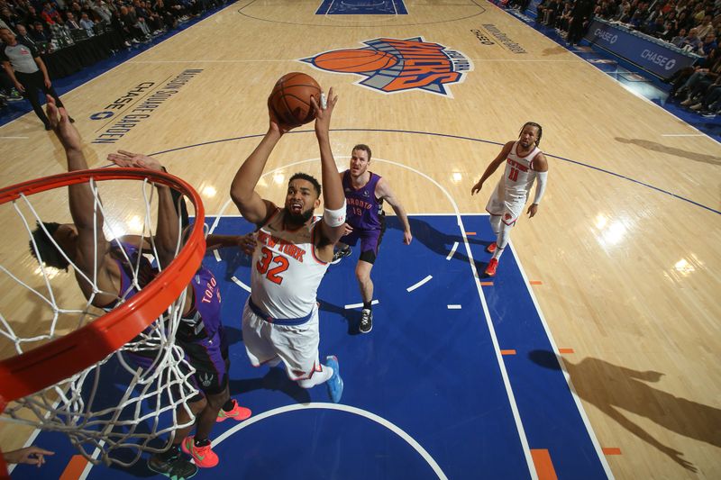 NEW YORK, NY - JANUARY 8:   Karl-Anthony Towns #32 of the New York Knicks drives to the basket during the game against the Toronto Raptors on January 8, 2025 at Madison Square Garden in New York City, New York.  NOTE TO USER: User expressly acknowledges and agrees that, by downloading and or using this photograph, User is consenting to the terms and conditions of the Getty Images License Agreement. Mandatory Copyright Notice: Copyright 2024 NBAE  (Photo by Nathaniel S. Butler/NBAE via Getty Images)