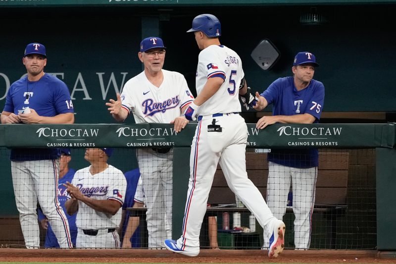 May 29, 2024; Arlington, Texas, USA;  Texas Rangers shortstop Corey Seager (5) celebrates his two-run home run with manager Bruce Bochy against the Arizona Diamondbacks during the fifth inning at Globe Life Field. Mandatory Credit: Jim Cowsert-USA TODAY Sports