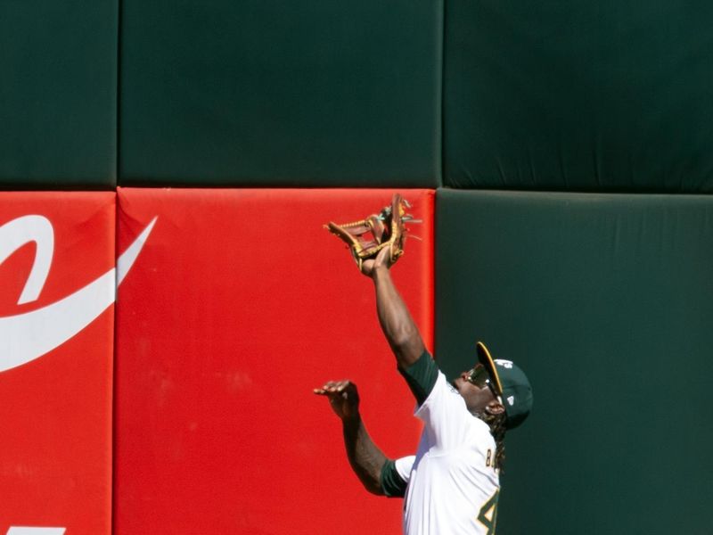 Sep 8, 2024; Oakland, California, USA; Oakland Athletics right fielder Lawrence Butler (4) makes the catch on the warning track of a fly ball by Detroit Tigers second baseman Colt Keith (33) during the fifth inning at Oakland-Alameda County Coliseum. Mandatory Credit: D. Ross Cameron-Imagn Images