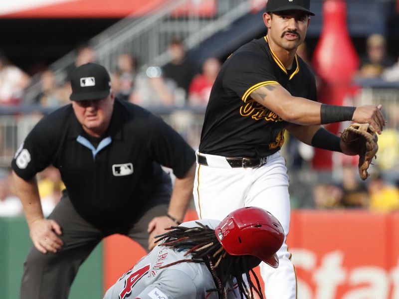 Jun 18, 2024; Pittsburgh, Pennsylvania, USA;  Pittsburgh Pirates second baseman Nick Gonzales (39) turns a double play over Cincinnati Reds shortstop Elly De La Cruz (44) during the first inning at PNC Park. Mandatory Credit: Charles LeClaire-USA TODAY Sports