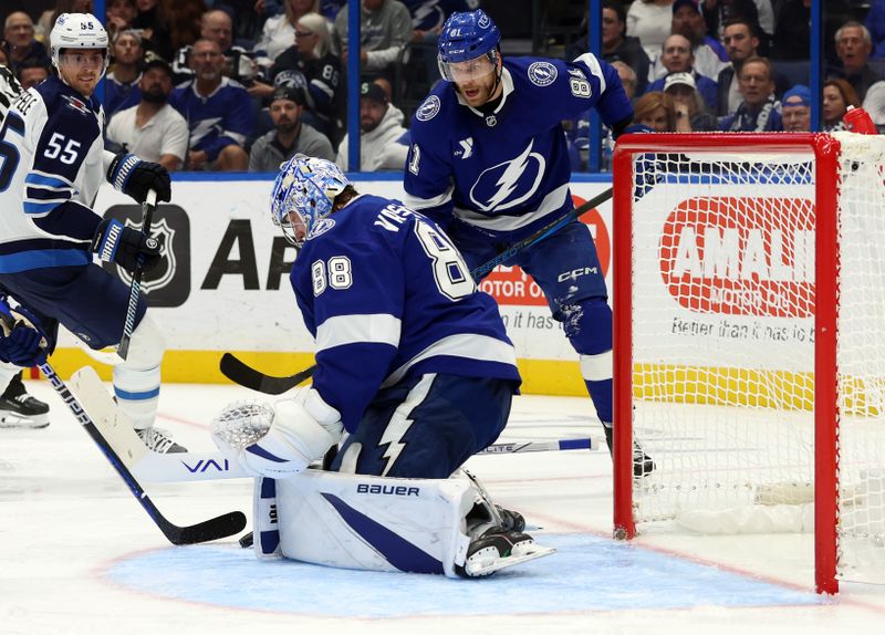 Nov 14, 2024; Tampa, Florida, USA; Tampa Bay Lightning goaltender Andrei Vasilevskiy (88) makes a save against the Winnipeg Jets during the second period at Amalie Arena. Mandatory Credit: Kim Klement Neitzel-Imagn Images