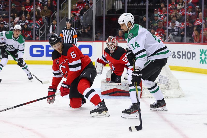 Jan 20, 2024; Newark, New Jersey, USA; Dallas Stars left wing Jamie Benn (14) plays the puck while being defended by New Jersey Devils defenseman John Marino (6) during the first period at Prudential Center. Mandatory Credit: Ed Mulholland-USA TODAY Sports