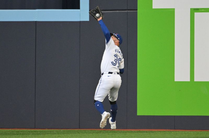 Jul 25, 2024; Toronto, Ontario, CAN;   Toronto Blue Jays right fielder Kevin Kiermaier (39) catches a fly ball hit by Tampa Bay Rays third baseman Amed Rosario (not shown) in the ninth inning at Rogers Centre. Mandatory Credit: Dan Hamilton-USA TODAY Sports