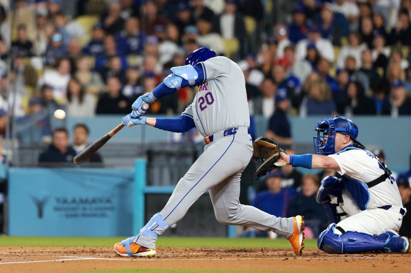 Apr 19, 2024; Los Angeles, California, USA;  New York Mets first base Pete Alonso (20) hits an RBI single during the third inning against the Los Angeles Dodgers at Dodger Stadium. Mandatory Credit: Kiyoshi Mio-USA TODAY Sports