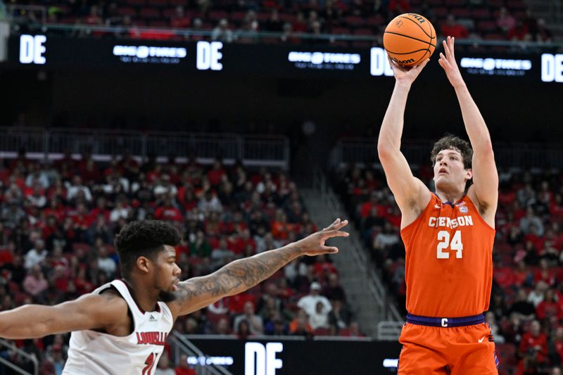 Feb 18, 2023; Louisville, Kentucky, USA;  Clemson Tigers center PJ Hall (24) shoots against Louisville Cardinals forward Sydney Curry (21) during the first half at KFC Yum! Center. Mandatory Credit: Jamie Rhodes-USA TODAY Sports