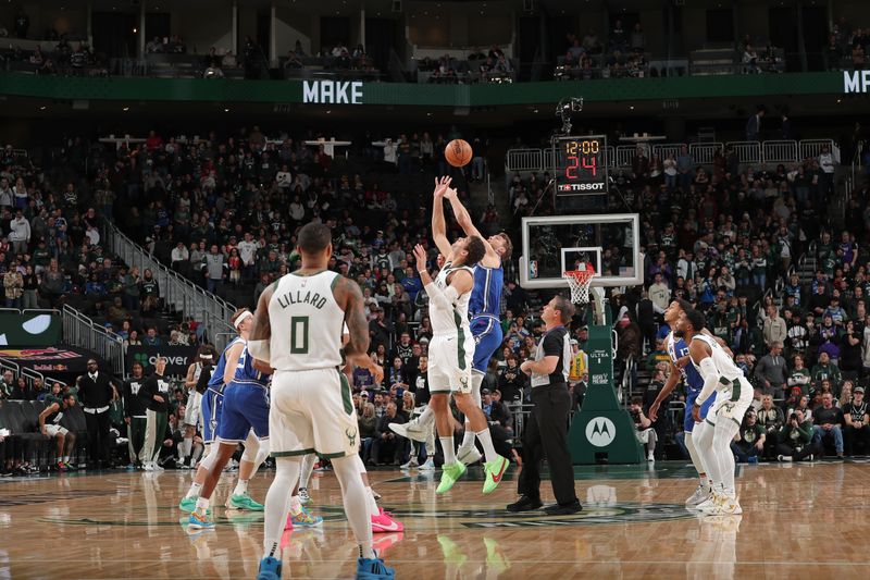 MILWAUKEE, WI - JANUARY 14: Brook Lopez #11 of the Milwaukee Bucks and Domantas Sabonis #10 of the Sacramento Kings go for the opening tip off during the game on January 14, 2024 at the Fiserv Forum Center in Milwaukee, Wisconsin. NOTE TO USER: User expressly acknowledges and agrees that, by downloading and or using this Photograph, user is consenting to the terms and conditions of the Getty Images License Agreement. Mandatory Copyright Notice: Copyright 2024 NBAE (Photo by Gary Dineen/NBAE via Getty Images).