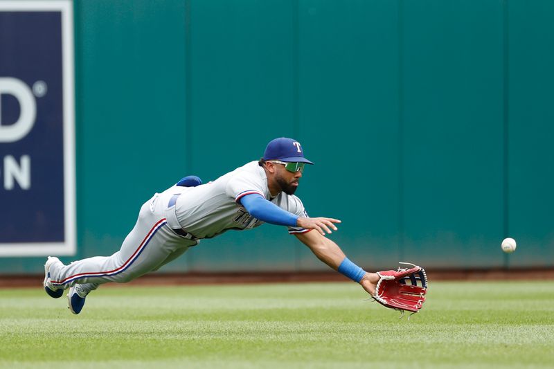 Jul 9, 2023; Washington, District of Columbia, USA; Texas Rangers center fielder Leody Taveras (3) dives while attempting to catch a line drive by Washington Nationals catcher Keibert Ruiz (not pictured) during the fourth inning at Nationals Park. Mandatory Credit: Geoff Burke-USA TODAY Sports