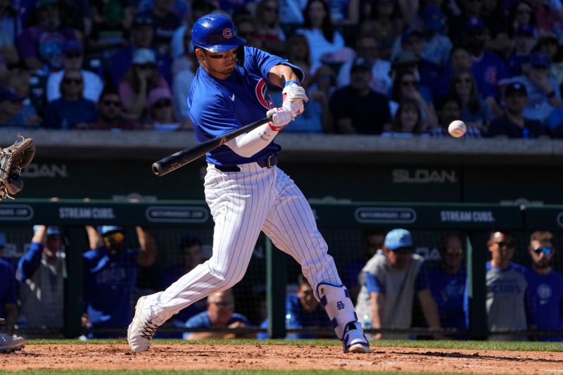 Mar 1, 2024; Mesa, Arizona, USA; Chicago Cubs right fielder Seiya Suzuki (27) hits against the Chicago White Sox during the third inning at Sloan Park. Mandatory Credit: Rick Scuteri-USA TODAY Sports