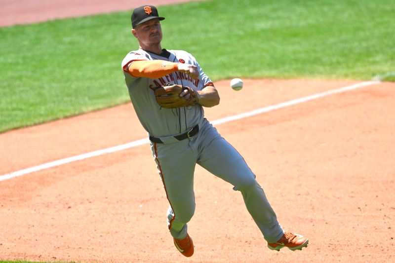 Jul 7, 2024; Cleveland, Ohio, USA; San Francisco Giants third baseman Matt Chapman (26) throws to first base in the sixth inning against the Cleveland Guardians at Progressive Field. Mandatory Credit: David Richard-USA TODAY Sports