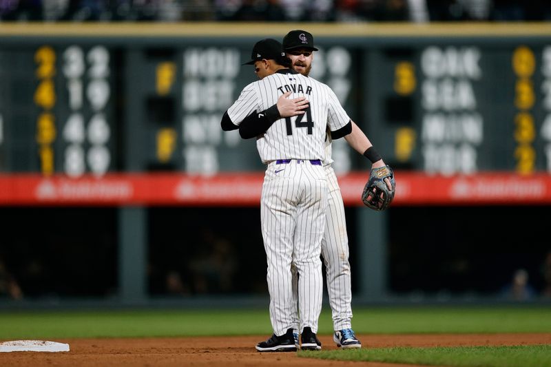 May 10, 2024; Denver, Colorado, USA; Colorado Rockies shortstop Ezequiel Tovar (14) and second baseman Brendan Rodgers (7) react after the game against the Texas Rangers at Coors Field. Mandatory Credit: Isaiah J. Downing-USA TODAY Sports