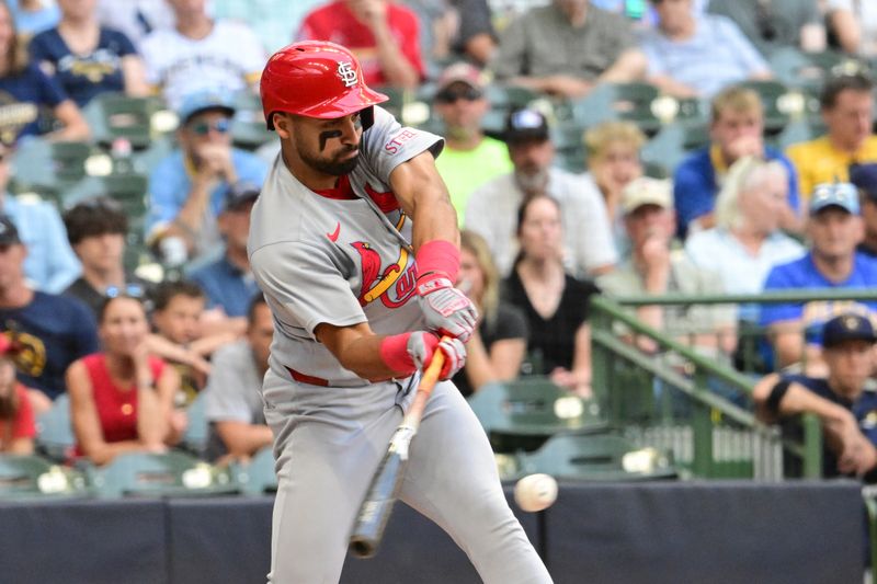 Sep 14, 2025; Milwaukee, Wisconsin, USA; St. Louis Cardinals second baseman Jose Fermin (15) drives in a run with a base hit against the Milwaukee Brewers in the second inning at American Family Field. Mandatory Credit: Benny Sieu-Imagn Images