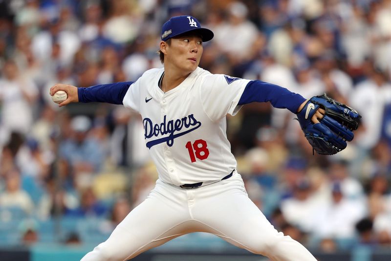 Oct 11, 2024; Los Angeles, California, USA; Los Angeles Dodgers pitcher Yoshinobu Yamamoto (18) pitches against the San Diego Padres in the first inning during game five of the NLDS for the 2024 MLB Playoffs at Dodger Stadium. Mandatory Credit: Kiyoshi Mio-Imagn Images