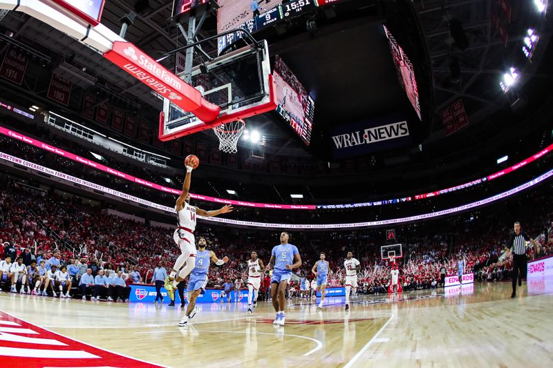 Feb 19, 2023; Raleigh, North Carolina, USA;  North Carolina State Wolfpack guard Casey Morsell (14) prepares to dunk the ball during the first half of the game against North Carolina Tar Heels at PNC Arena. Mandatory Credit: Jaylynn Nash-USA TODAY Sports