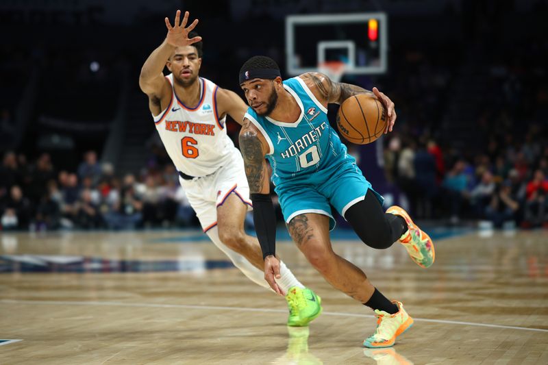 CHARLOTTE, NORTH CAROLINA - JANUARY 29: Miles Bridges #0 of the Charlotte Hornets drives to the basket against Quentin Grimes #6 of the New York Knicks during the first half of the game at Spectrum Center on January 29, 2024 in Charlotte, North Carolina. NOTE TO USER: User expressly acknowledges and agrees that, by downloading and or using this photograph, User is consenting to the terms and conditions of the Getty Images License Agreement. (Photo by Jared C. Tilton/Getty Images)