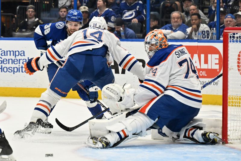 Feb 25, 2025; Tampa, Florida, USA;  Edmonton Oilers goal keeper Stuart Skinner (74) blocks a shot in the first  period against the Tampa Bay Lightning at Amalie Arena. Mandatory Credit: Jonathan Dyer-Imagn Images