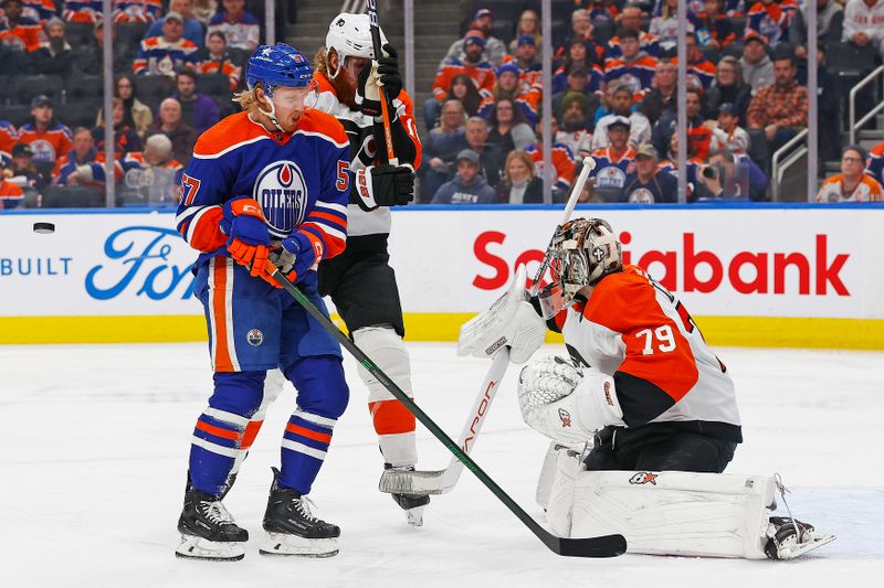 Jan 2, 2024; Edmonton, Alberta, CAN; Edmonton Oilers /forward James Hamblin (57) tries to deflect a shot past Philadelphia Flyers goaltender Carter Hart (79) during the first period at Rogers Place. Mandatory Credit: Perry Nelson-USA TODAY Sports